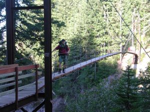 Carl on suspension bridge over Tahoma Creek