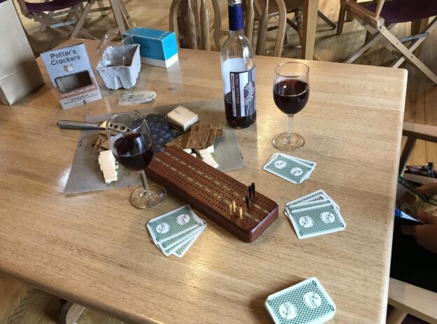 Cribbage board and wine